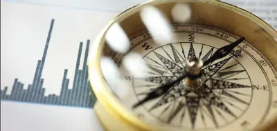 photo of a compass next to a graph