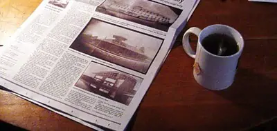 a cup of coffee next to a newspaper