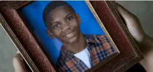 Image: Framed photograph of Neli Latson, a young black man.