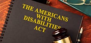 A notebook that says "The Americans with Disabilities Act" on the front