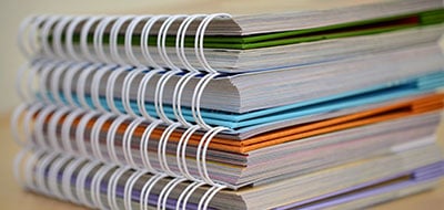a stack of spiral-bound documents