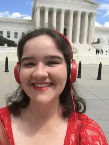 Grace Hart smiles in front of the Lincoln Memorial