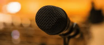 a microphone with a blurry orange background