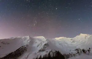 snowy mountains under a starry sky