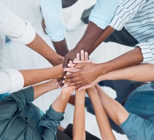 Group of people's hands on top of each other.